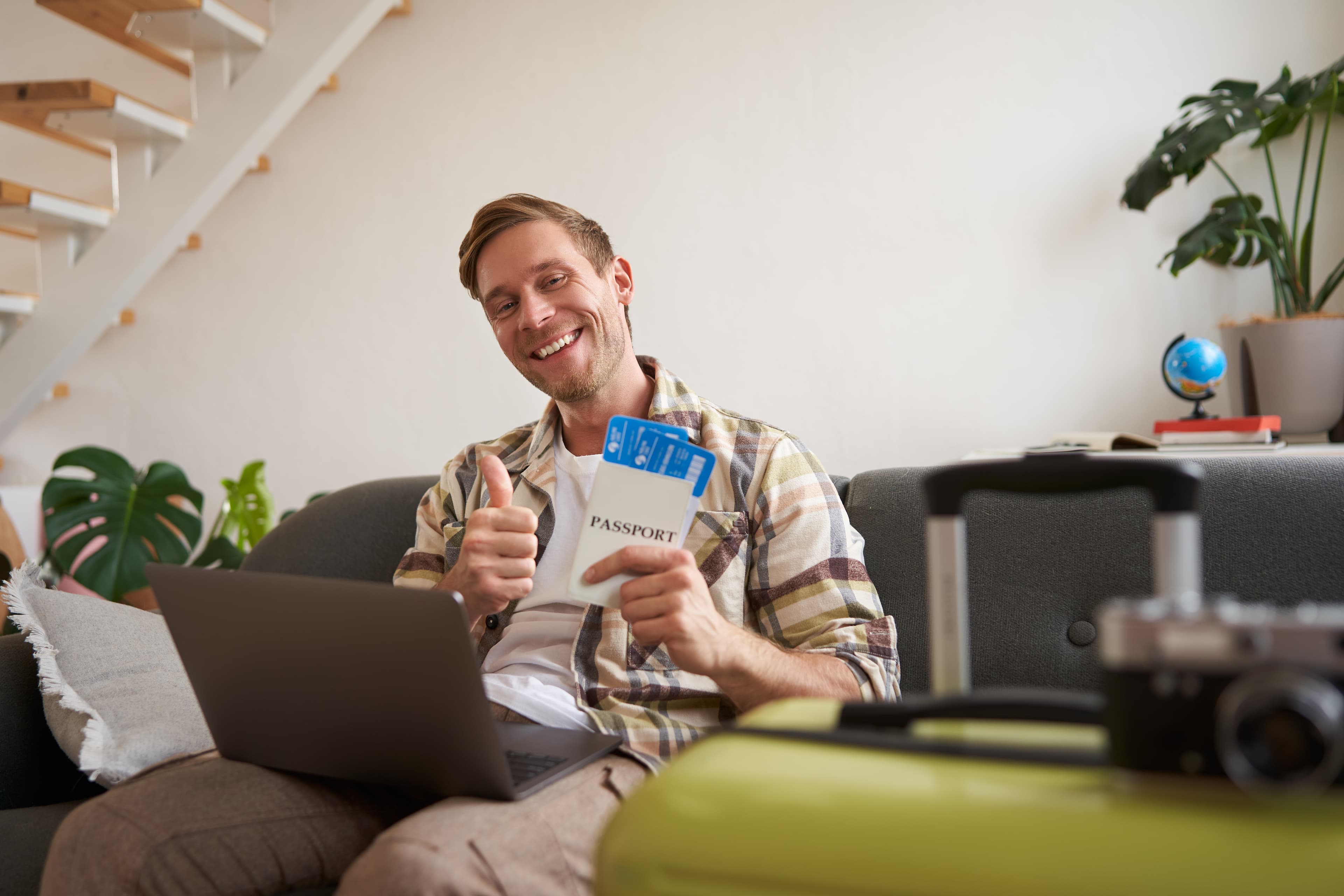 A woman smiling while using a tablet at home
